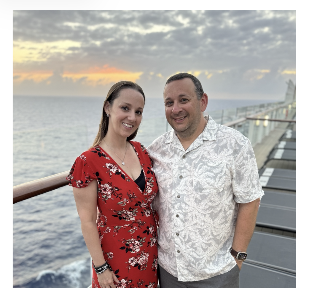 Aaron C. Lee — Owner, SourcePoint Travel, with his wife aboard a cruise ship at sunset